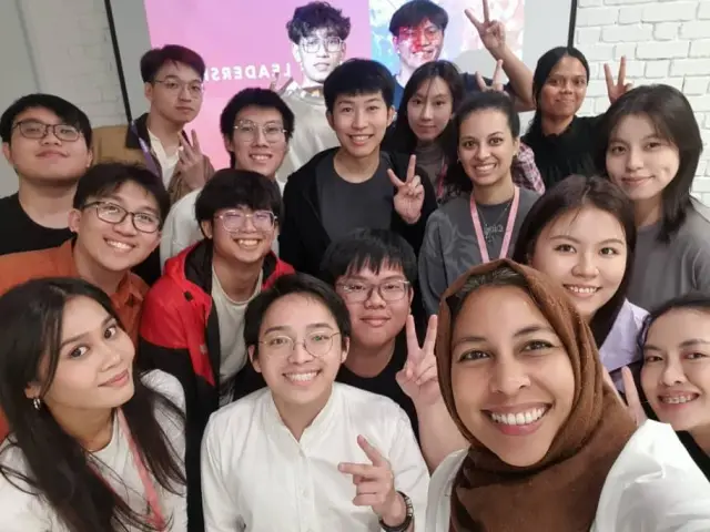 Participants taking a group selfie after a session