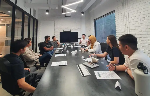 Founders in discussion around a meeting table at The Dune