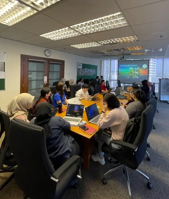 A team workshop with participants at laptops